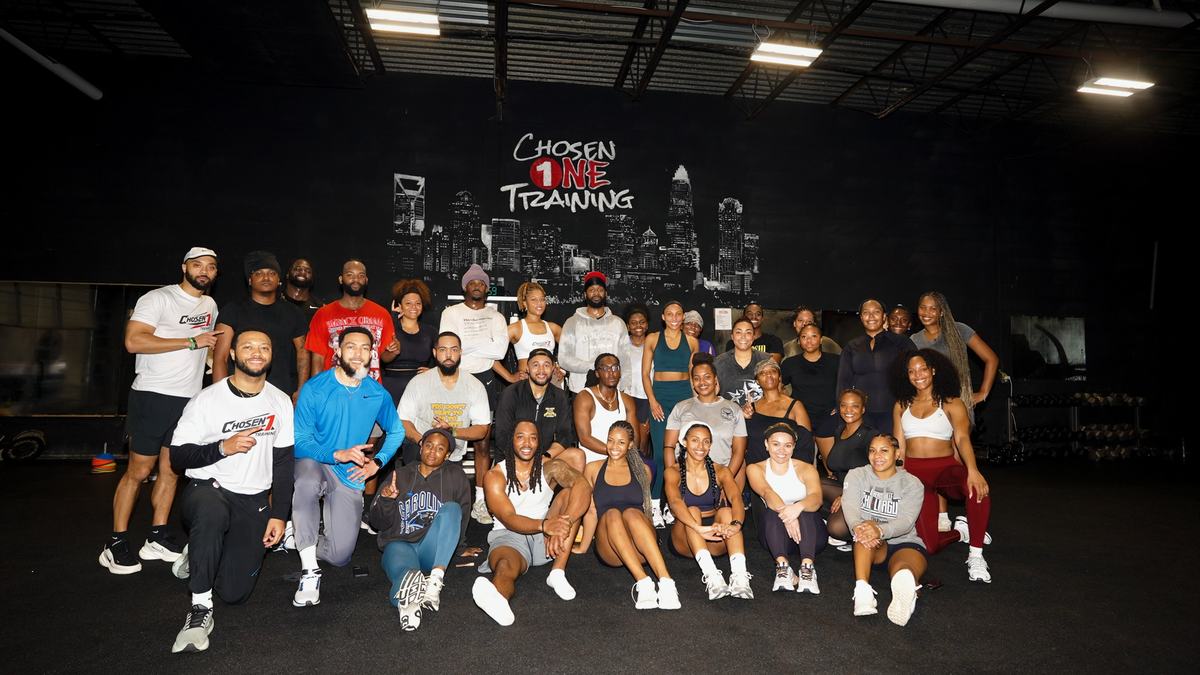 A large group of athletes posing together after a Recovery1 session at Chosen 1 Training in Charlotte