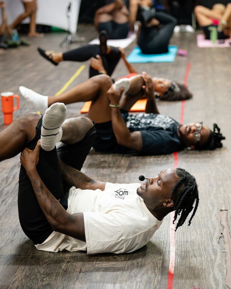 Recovery Specialist John Brannon leading a group through a lying hamstring stretch